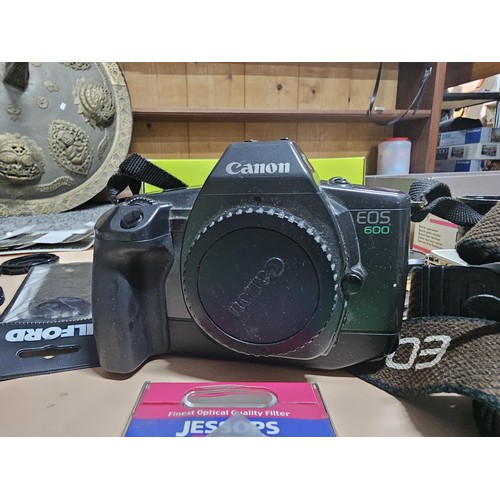 165 - A large quantity of photographic related items to include a Cannon EOS 600 camera along with and ass... 