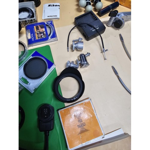 165 - A large quantity of photographic related items to include a Cannon EOS 600 camera along with and ass... 