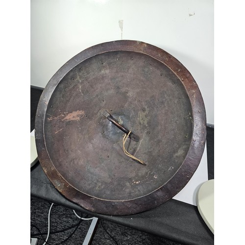 169 - An antique early 20th century Indo-Persian metal Dhal shield with grip bar, the shield is decorated ... 