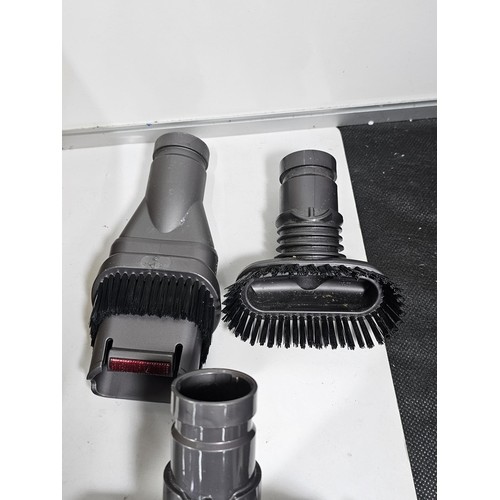 173 - A box containing a quantity of Dyson accessories to include 3x rotating brush heads, additional brus... 