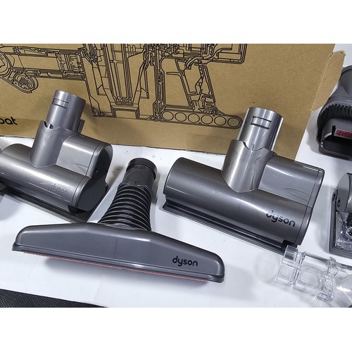 173 - A box containing a quantity of Dyson accessories to include 3x rotating brush heads, additional brus... 