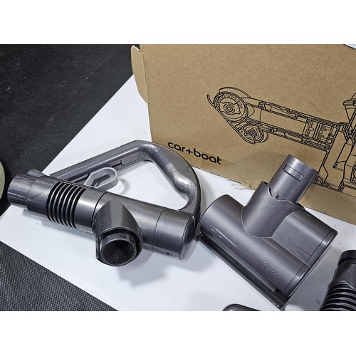 173 - A box containing a quantity of Dyson accessories to include 3x rotating brush heads, additional brus... 
