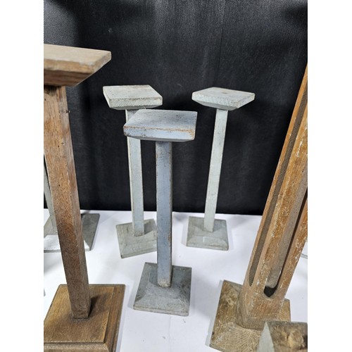 178 - A collection of 11x good quality wooden pillar candle stands two include 5x candle stands with open ... 