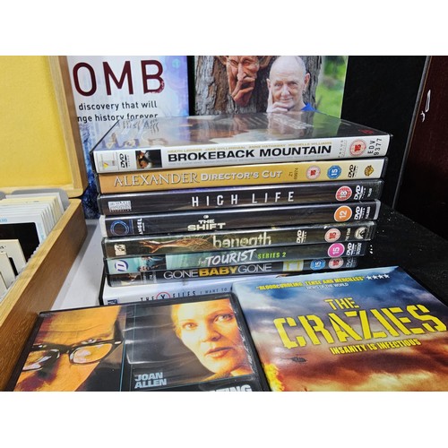 182 - A collection of books and DVD's and CD's to include Brokeback Mountain, The Contender, The Hunter et... 
