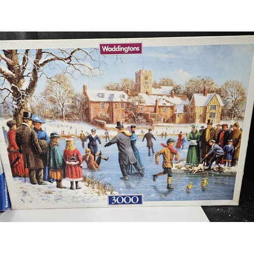 183 - A collection of 4x jigsaws to include 3x 3000 piece jigsaws and one 2000 piece by Waddingtons and Ra... 