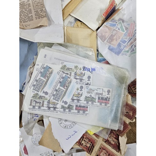 202 - A red hold bag containing a very large quantity of assorted loose stamps to include British stamps, ... 