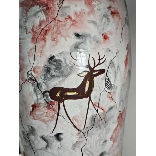 203 - A large earthenware floor standing vase with hand painted decoration to the side showing the image o... 