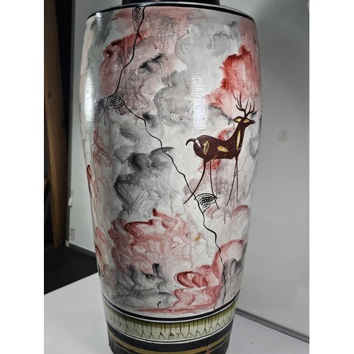 203 - A large earthenware floor standing vase with hand painted decoration to the side showing the image o... 