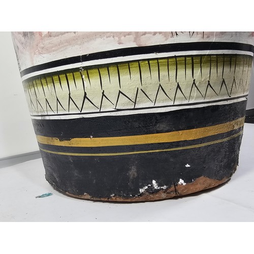 203 - A large earthenware floor standing vase with hand painted decoration to the side showing the image o... 
