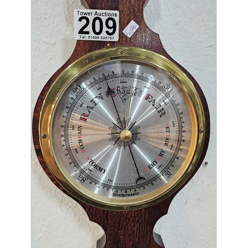 209 - A modern, mahogany banjo barometer by Weathermaster with a barometer to the base and thermometer to ... 