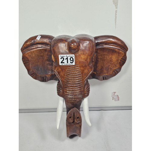 219 - A good quality solid wood hand carved elephant head figure with good detailing to the face and front... 