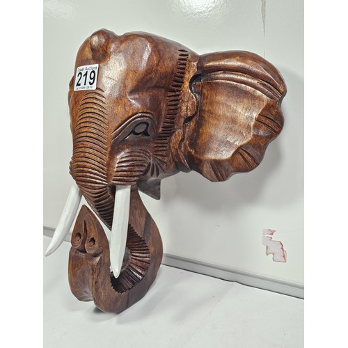 219 - A good quality solid wood hand carved elephant head figure with good detailing to the face and front... 