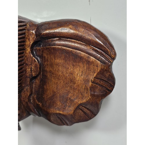219 - A good quality solid wood hand carved elephant head figure with good detailing to the face and front... 