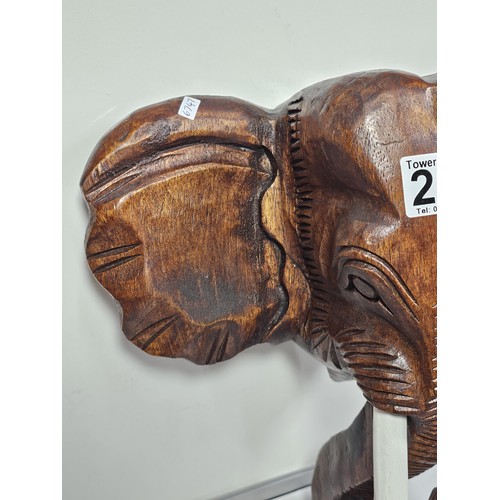 219 - A good quality solid wood hand carved elephant head figure with good detailing to the face and front... 