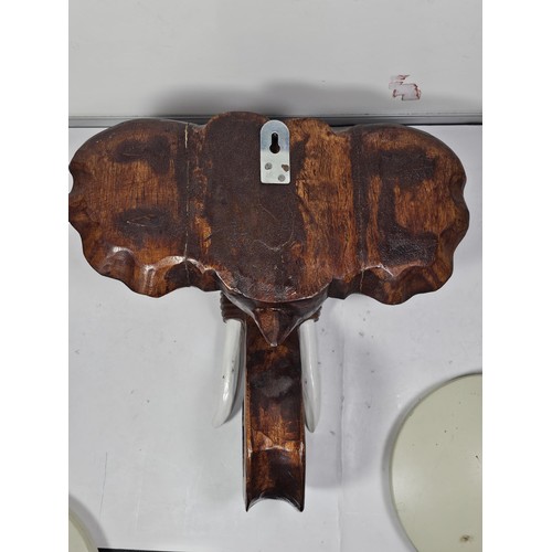 219 - A good quality solid wood hand carved elephant head figure with good detailing to the face and front... 