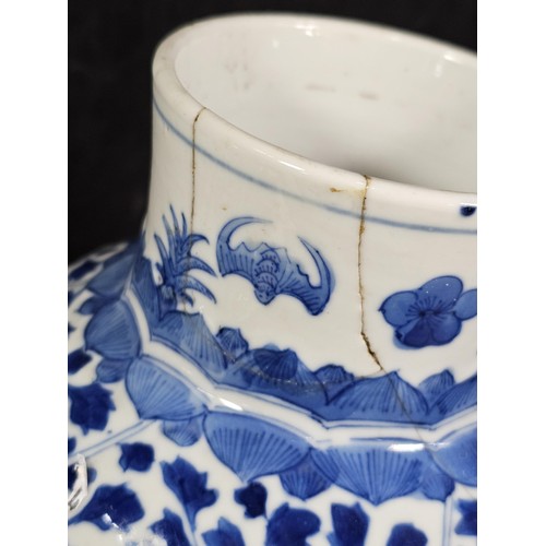 235 - A pair of Chinese blue and white lidded vases decorated with dense floral patterns in under glazed c... 