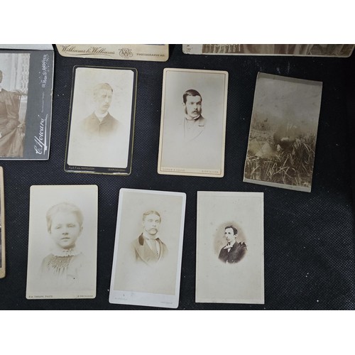 215A - A large collection of approx 56 antique photographic cards featuring various portraits set onto hard... 