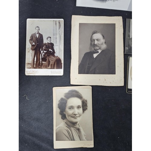215A - A large collection of approx 56 antique photographic cards featuring various portraits set onto hard... 