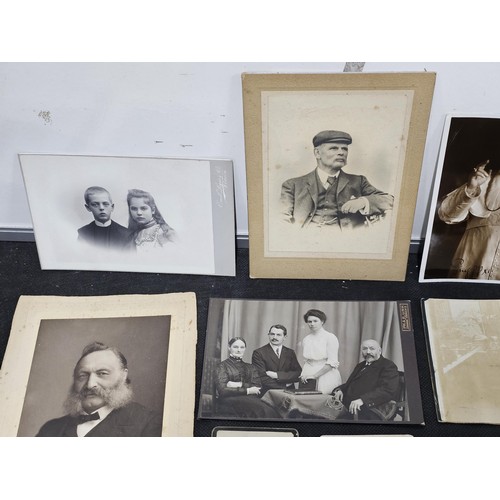 215A - A large collection of approx 56 antique photographic cards featuring various portraits set onto hard... 