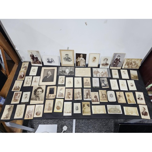 215A - A large collection of approx 56 antique photographic cards featuring various portraits set onto hard... 