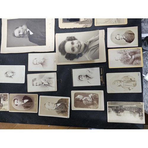 215A - A large collection of approx 56 antique photographic cards featuring various portraits set onto hard... 