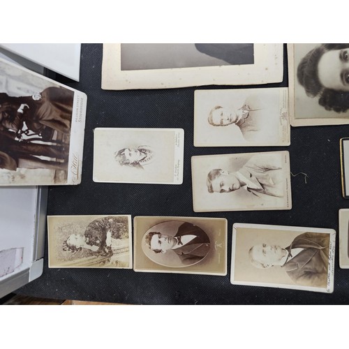 215A - A large collection of approx 56 antique photographic cards featuring various portraits set onto hard... 