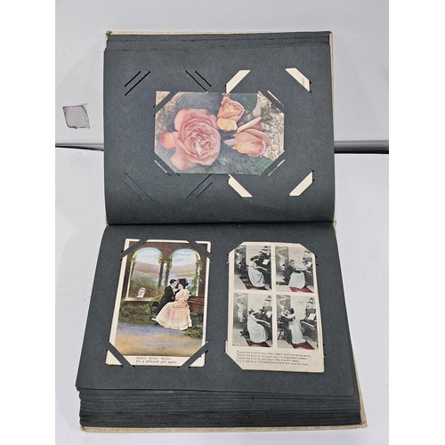 215E - Complete album of vintage and antique postcards to include humorous postcards photographic postcards... 