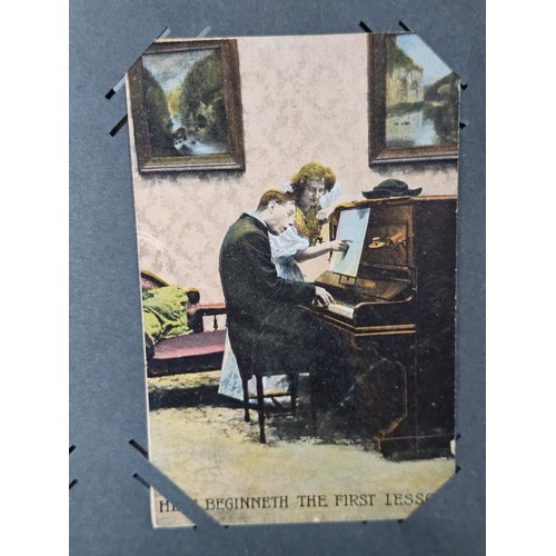 215E - Complete album of vintage and antique postcards to include humorous postcards photographic postcards... 