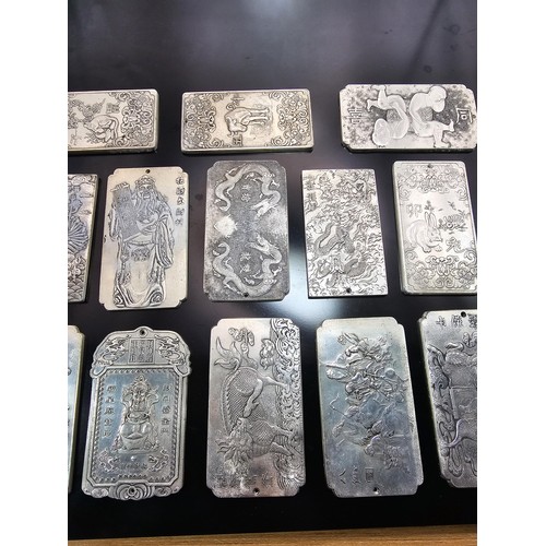 A collection of 14x Chinese white metal plaques of various designs ...