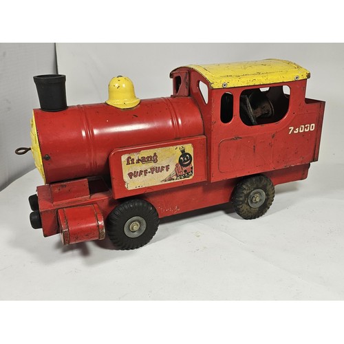 17 - A Tri-ang 'Puff-Puff' lithographed tin plate push along locomotive, red and ye;ow livery with a cart... 