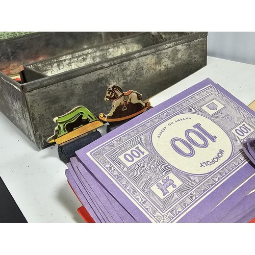 18 - A Collection of vintage games to include a tin containing a vintage Monopoly game dating from the 19... 