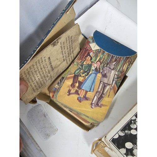 18 - A Collection of vintage games to include a tin containing a vintage Monopoly game dating from the 19... 