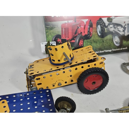 24 - A small quantity of Meccano, to include a partially built armoured car and a trailer along with a co... 