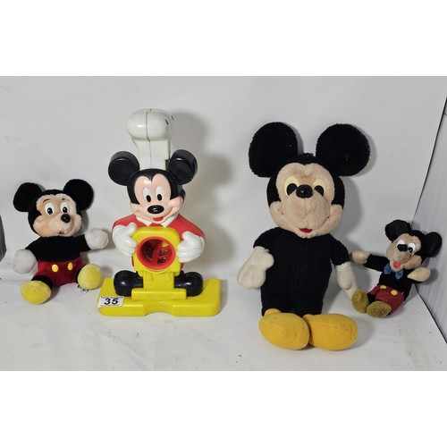 35 - A collection of Mickey Mouse items to include a genuine Disney Mickey mouse plush toy with label, a ... 
