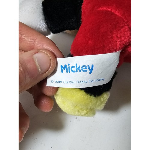 35 - A collection of Mickey Mouse items to include a genuine Disney Mickey mouse plush toy with label, a ... 
