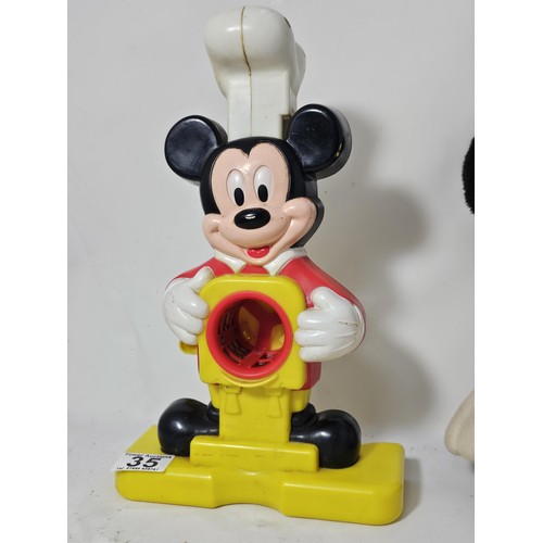 35 - A collection of Mickey Mouse items to include a genuine Disney Mickey mouse plush toy with label, a ... 