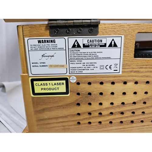 42 - A reproduction record player in a wooden case, fitted with a CD player and radio, in full working or... 