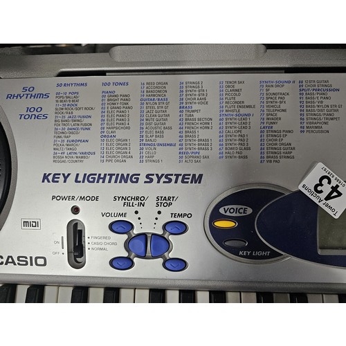 43 - A Casio keyboard model LK-43 with 100 preset tones and 50 rhythm, complete with digital display to t... 