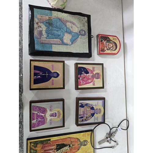 53 - 2 shelves containing a collection of religious related items, to include 11 Russian style iconograph... 