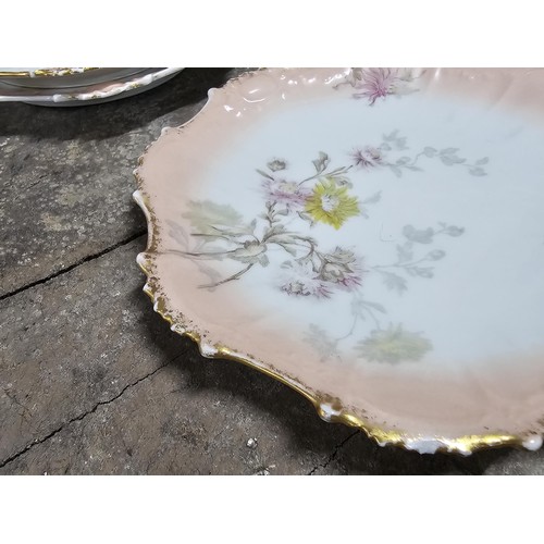 55A - A part set of early 20th century Limoges porcelain comprising of 10 hand painted cabinet plates and ... 