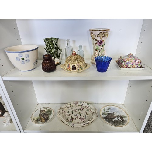 55 - A shelf full of collectables to include, a James Kent floral butter dish, a hand painted Belgium vas... 