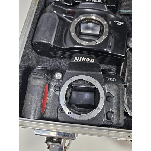 A aluminum camera case containing a quantity of 6x assorted camera ...