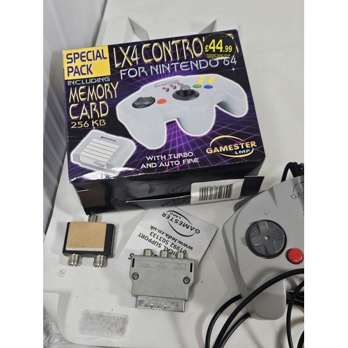 A boxed Nintendo 64 with original controller and a gamester controller ...