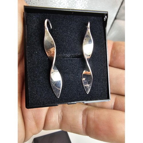 237 - A pair of as new unused 925 silver drop earrings, having a shaped twist design which catches the lig... 