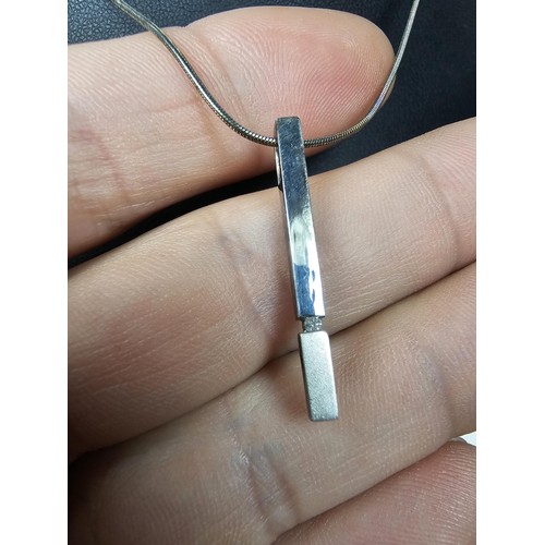 215 - A 925 silver pendant necklace featuring a bar formed silver pendant set with a real round cut diamon... 