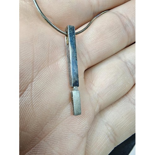 215 - A 925 silver pendant necklace featuring a bar formed silver pendant set with a real round cut diamon... 