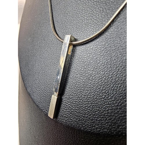 215 - A 925 silver pendant necklace featuring a bar formed silver pendant set with a real round cut diamon... 