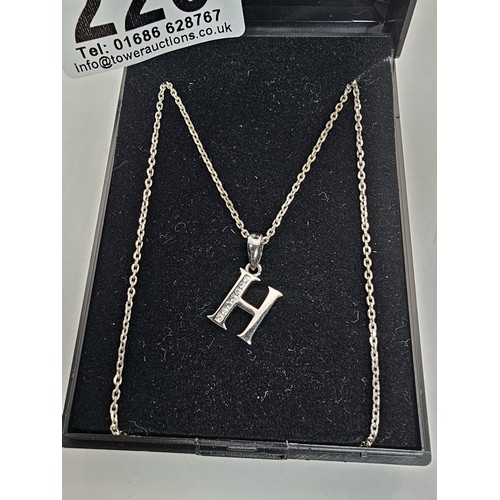 220 - A 925 silver pendant necklace featuring a silver letter H pendant set with sparkly crystal CZ stones... 