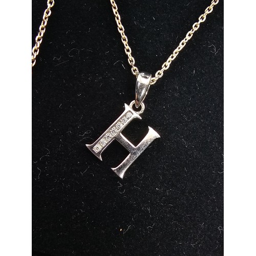 220 - A 925 silver pendant necklace featuring a silver letter H pendant set with sparkly crystal CZ stones... 