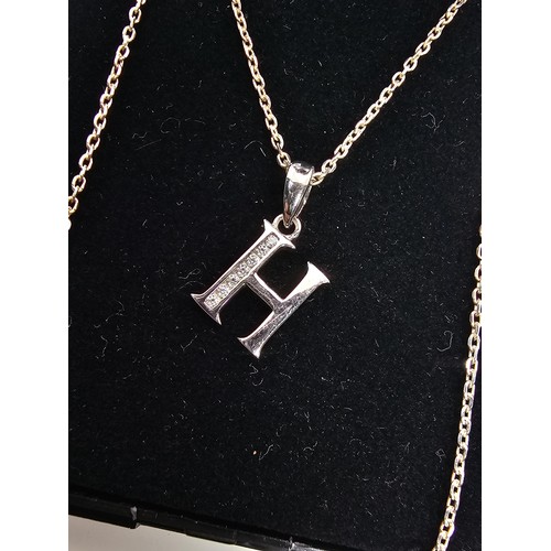 220 - A 925 silver pendant necklace featuring a silver letter H pendant set with sparkly crystal CZ stones... 